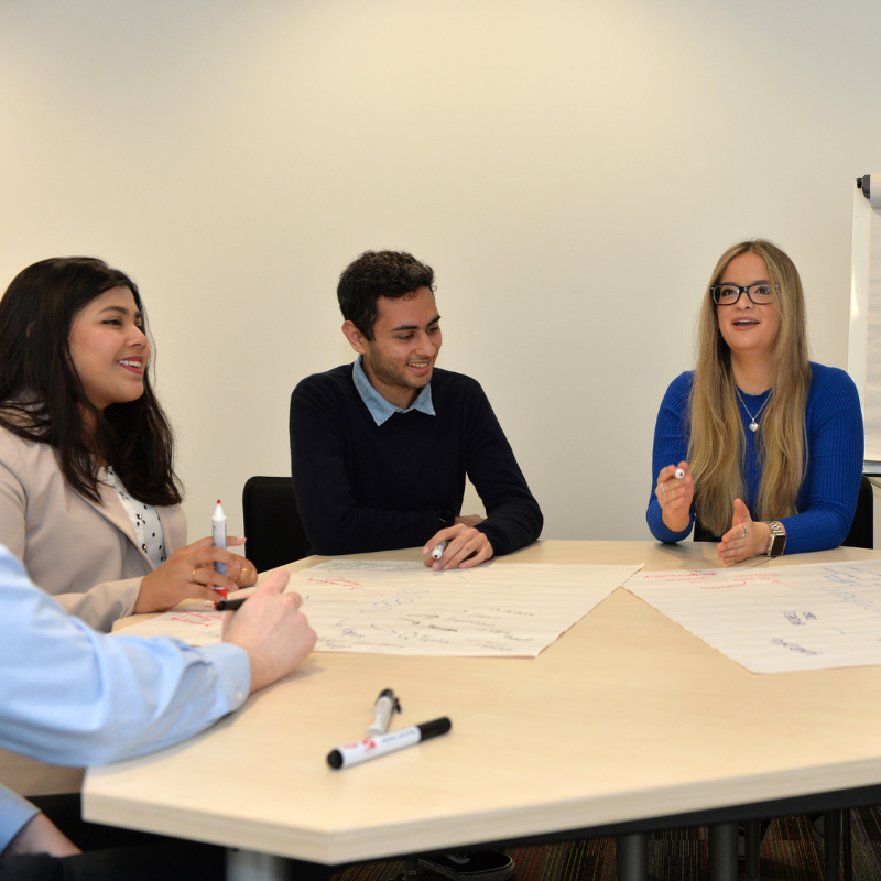 A group of students sat at a table doing some group work